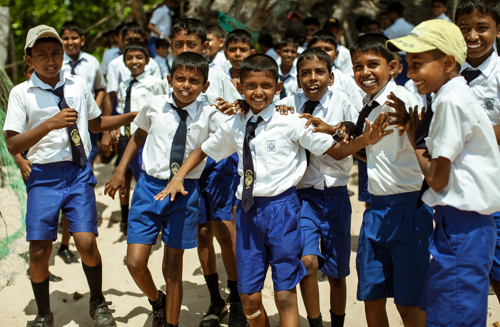 School children dressed in uniform have fun and play in the schoolyard. Wadduwa, Sri-Lanka.